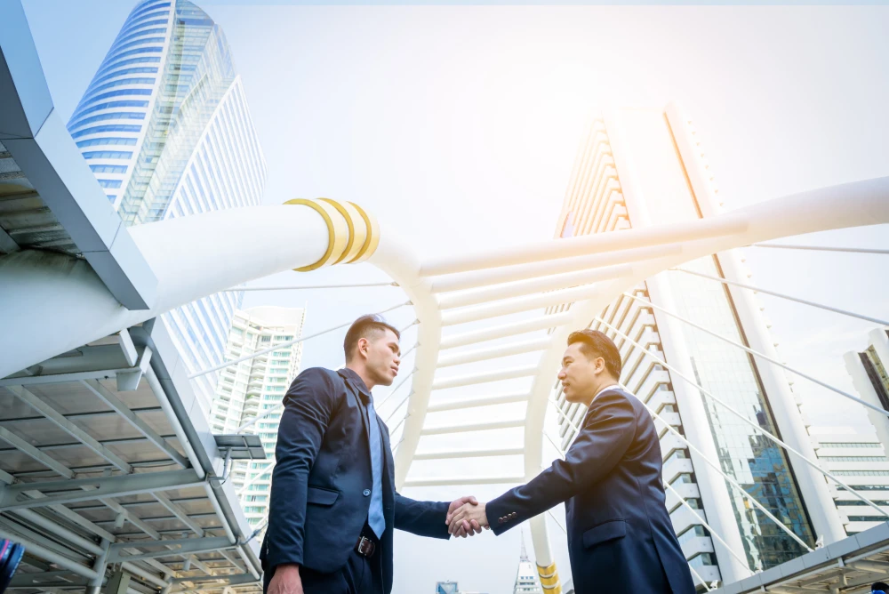 two asian business have handshake with building an 2025 10 16 23 27 19 utc.webp